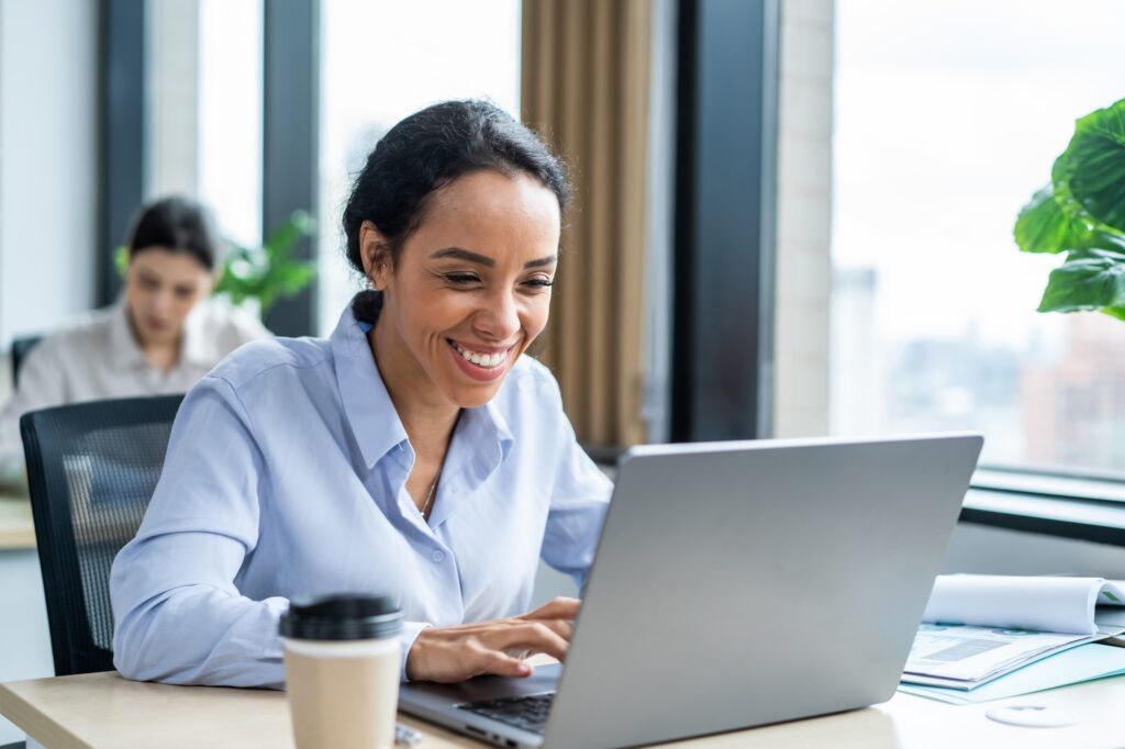 Latino beautiful businesswoman using laptop computer working in office.